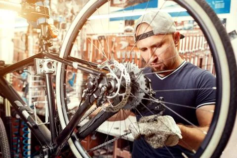 Bicycle mechanic in a workshop in the repair process Stock Photos