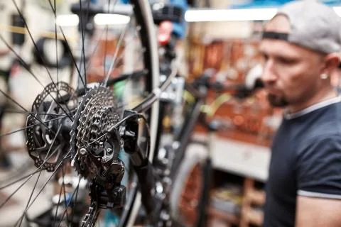 Bicycle mechanic in a workshop in the repair process Stock Photos