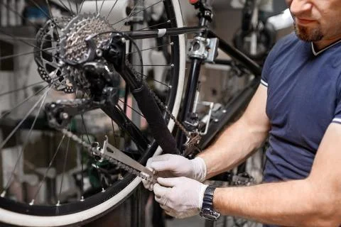 Bicycle mechanic in a workshop in the repair process Stock Photos