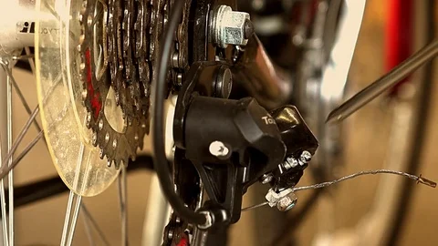 Bicycle owner adjusting rear derailleur. Stock Footage