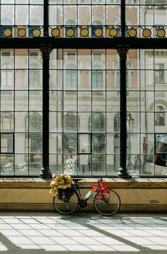 Bicycle parked in front of big glass window Stock Photos