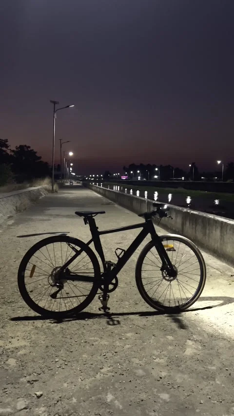 Bicycle Parked on Roadside at Night Stock Footage 345632073