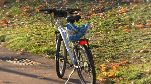 A bicycle parked on the side of the road Stock Footage