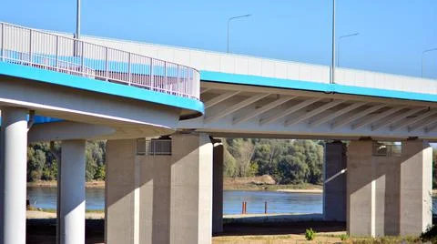 Bicycle path and sidewalk through the highway bridge. Stock Photos