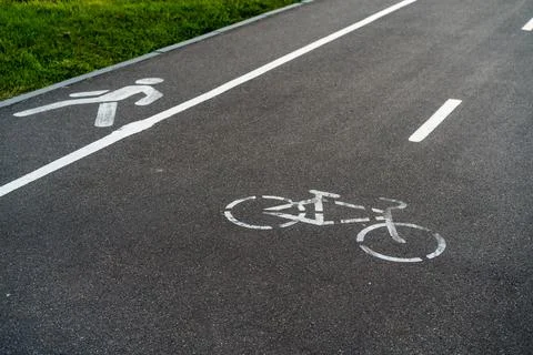 Bicycle path, bicycle and running track, pedestrian sign on asphalt Stock Photos