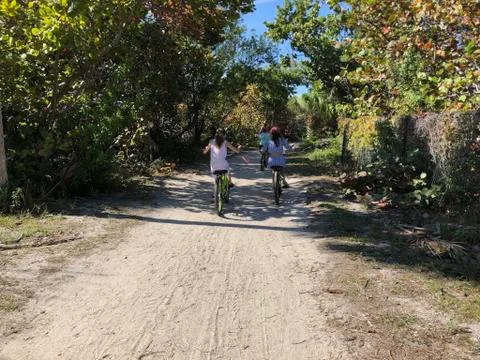 Bicycle path with cyclists on remote island Stock Photos