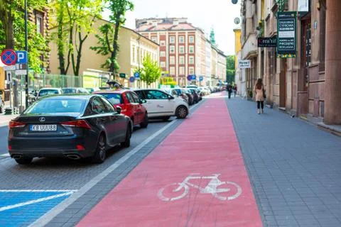 Bicycle path on the sidewalk highlighted in red. Krakow, Poland - 05.15.2019 Stock Photos