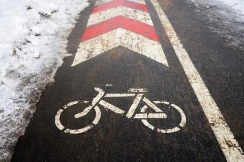 Bicycle path in winter under the snow. The bike season is closed due to ice. Stock Photos