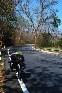 Bicycle on paved road Stock Photos