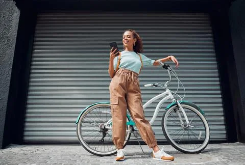 Bicycle, phone and black woman in city, street or urban road outdoors. Bike Stock Photos