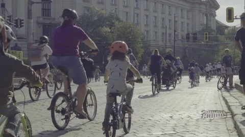 Bicycle procession along the yellow-paved boulevard in Sofia 動画素材 346375234