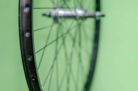 Bicycle repair workshop. On the hook hang new wheels. The hub is black and th Stock-Fotos