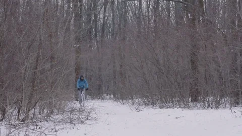 Bicycle rider on snow Stock Footage 85385399