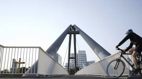 Bicycle riding on modern bridge Stock Footage 101027967