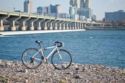 Bicycle at the riverside Stock Photos