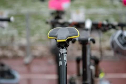 Bicycle saddle with more bicycles in the blur in the background 스톡 사진
