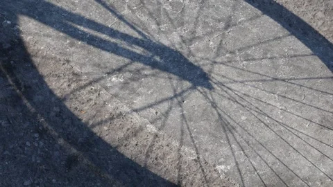Bicycle Shadow Cast on Concrete Ground Stock Footage 329227347