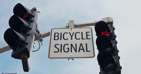 Bicycle sign coupled with a cyclist-specific signal light underscores the cities Vídeos de archivo 274179802