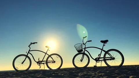Bicycle Silhouettes at Sunrise on the Beach Stock Footage