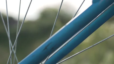 Bicycle spoke over a grass background, slow motion. Eco-friendly Video stock 103839007