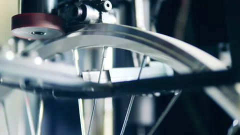 Bicycle spokes are getting regulated by a factory mechanism Stock Footage 146638482