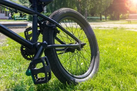 Bicycle standing on the grass in the sunlight in the spring morning Stock Photos