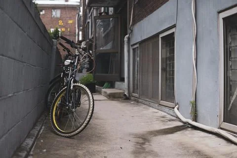 A bicycle is standing on the wall column. Stock Photos
