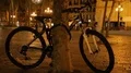 Bicycle tied to tree at night city park, environmentally friendly transport HD Footage