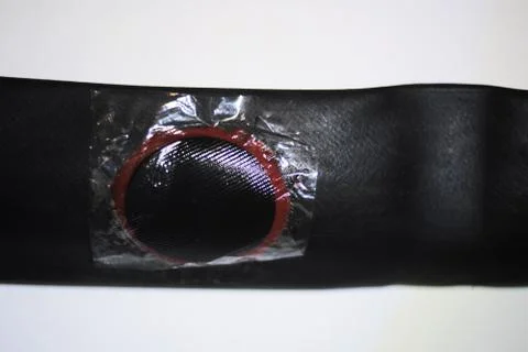 Bicycle tire with applied patch close up on white Stock Photos