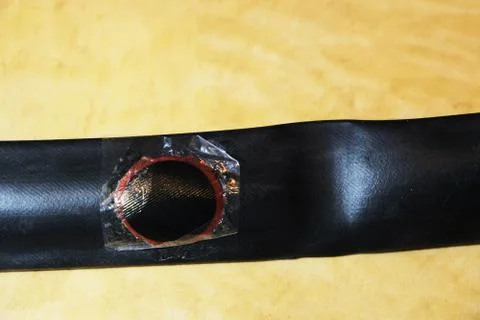 Bicycle tire with applied patch close up on yellow Stock Photos