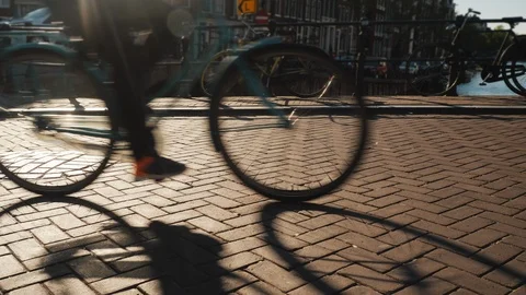 Bicycle traffic on the bridge over the canal in Amsterdam. Before sunset Stock Footage 100985390