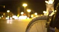 Bicycle wheel close-up, defocused night traffic timelapse, urban transport 4k or 4k+ Resolution