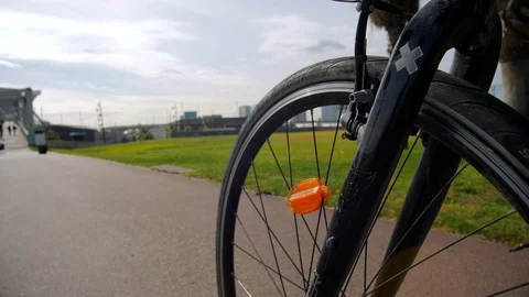Bicycle Wheel close-up. Forum Park and City on Background. Barcelona Stock Footage 97572553