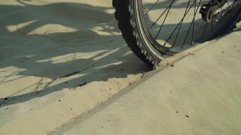 Bicycle wheel glides on the sand Stock Footage 156041685