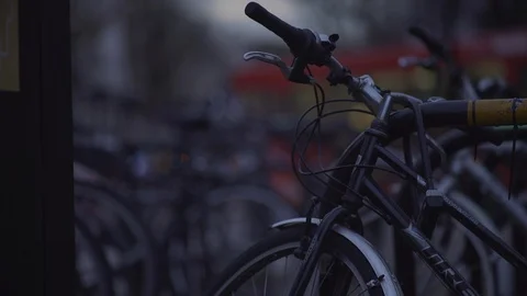 Bicycle wheel handlebars defocused headlights at Dusk Stock Footage 90217880