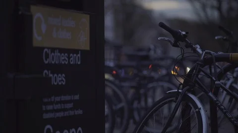Bicycle wheel handlebars recycle unit and defocused headlights at Dusk Stock Footage 90217466