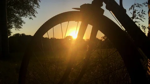 Bicycle wheel at sunset Stock Footage 130140642
