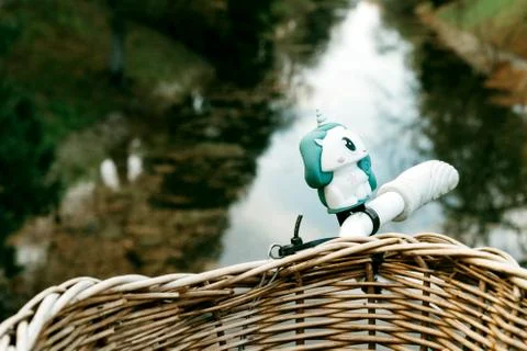Bicycle wicker basket on the background of the river channel in the city Stock Photos