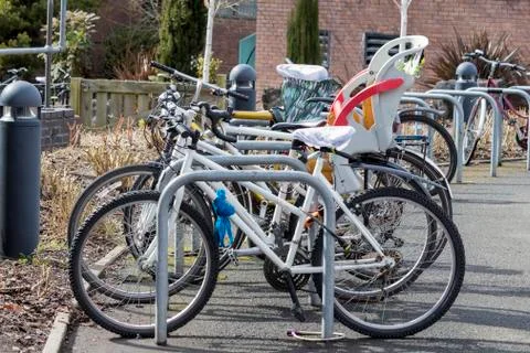 Bicycles chained in a rack with one including a child seat Stock Photos