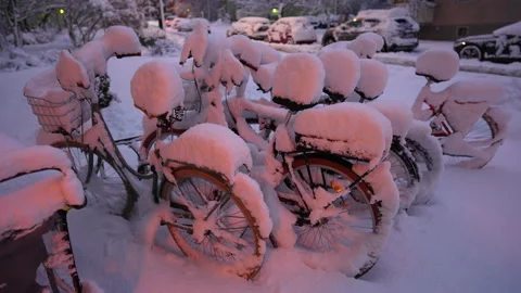 Bicycles covered and trapped below snow during heavy snowfall Stock Footage 236290709