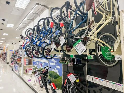 Bicycles displayed on a wall rack inside a retail department store - 07.05... Foto stock