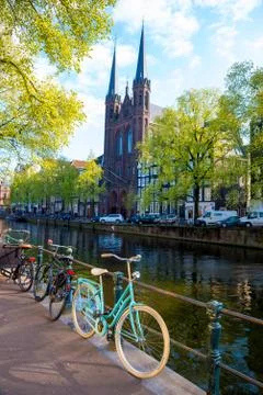 Bicycles lining a bridge over the canals of Amsterdam, Netherlands Stock Photos
