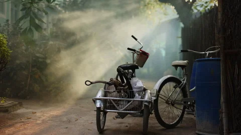 Bicycles stand in the rays of light. The sun's rays pass through the smoke Stock-Footage 240331617