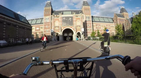 Bicycling towards and under Rijksmuseum, Amsterdam. Stock Footage