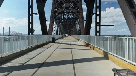 Bicyclist Rides in Front of Tracking Camera Big Four Bridge Louisville Stock Footage 65929075