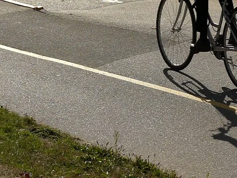Bicyclist shadow moving on asphalt slow motion Stock Footage 80972707