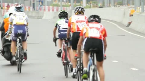 Bicyclists race away from camera Stock Footage 10818563