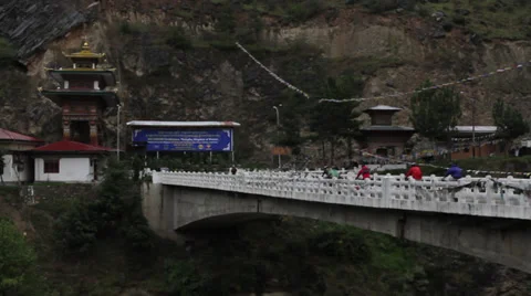 Bicyclists riding over bridge in Bhutan 스톡 동영상 37161453