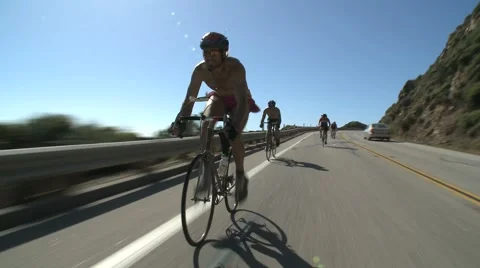 Bicyclists Zooming downhill Stock Footage
