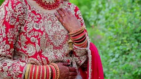 Bide is folding her hands, dressed in traditional red Indian clothes, Elements Stock Footage 310431026